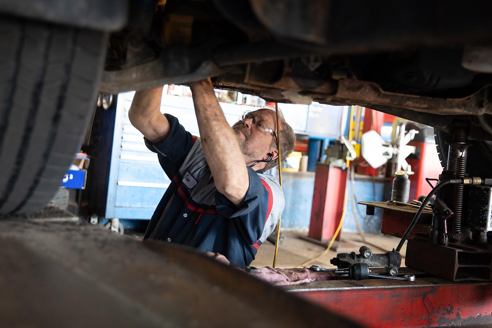 Mechanic Fixing Underneath Car | Auto Repair Shop
